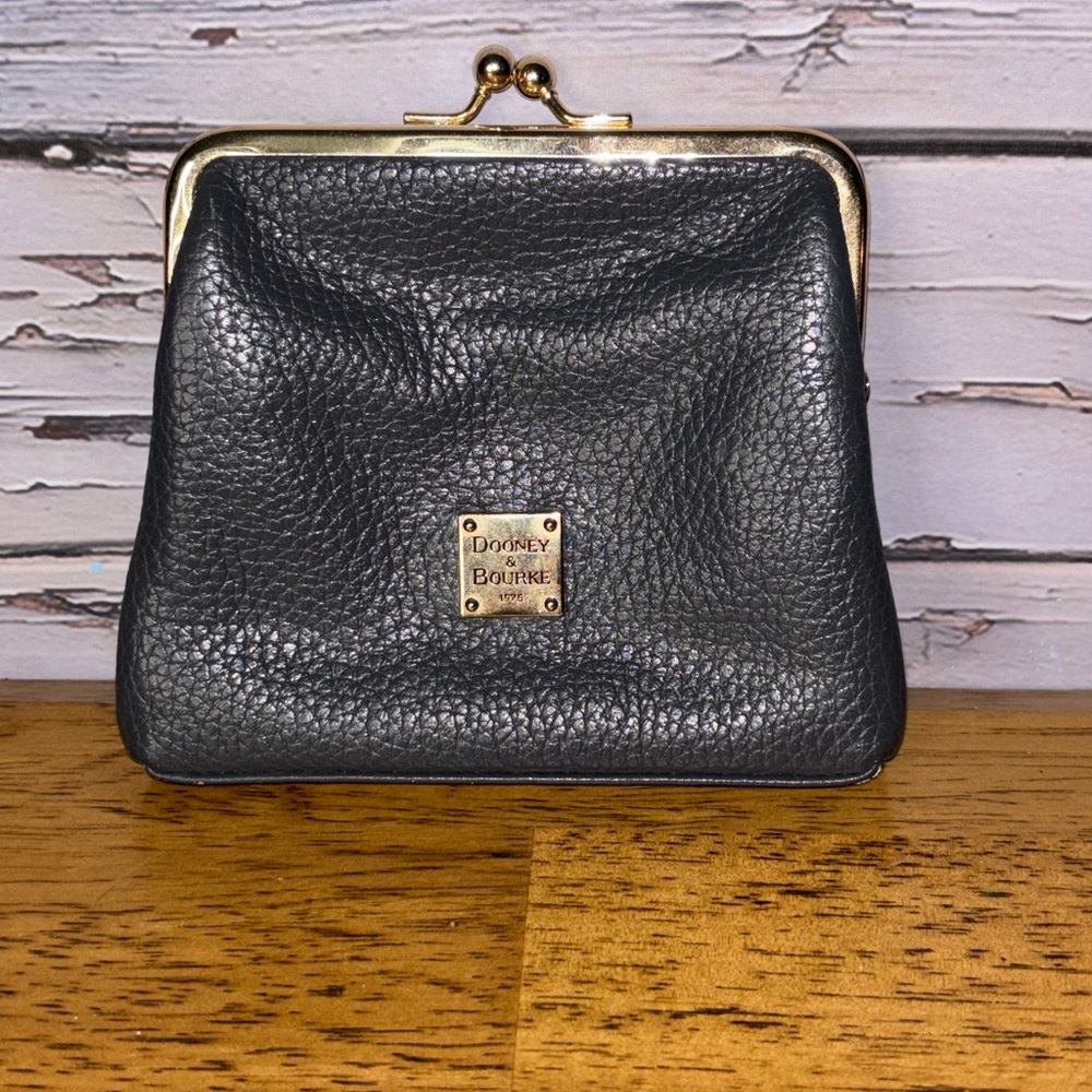 Dooney & Bourke leather large framed kiss lock pouch.